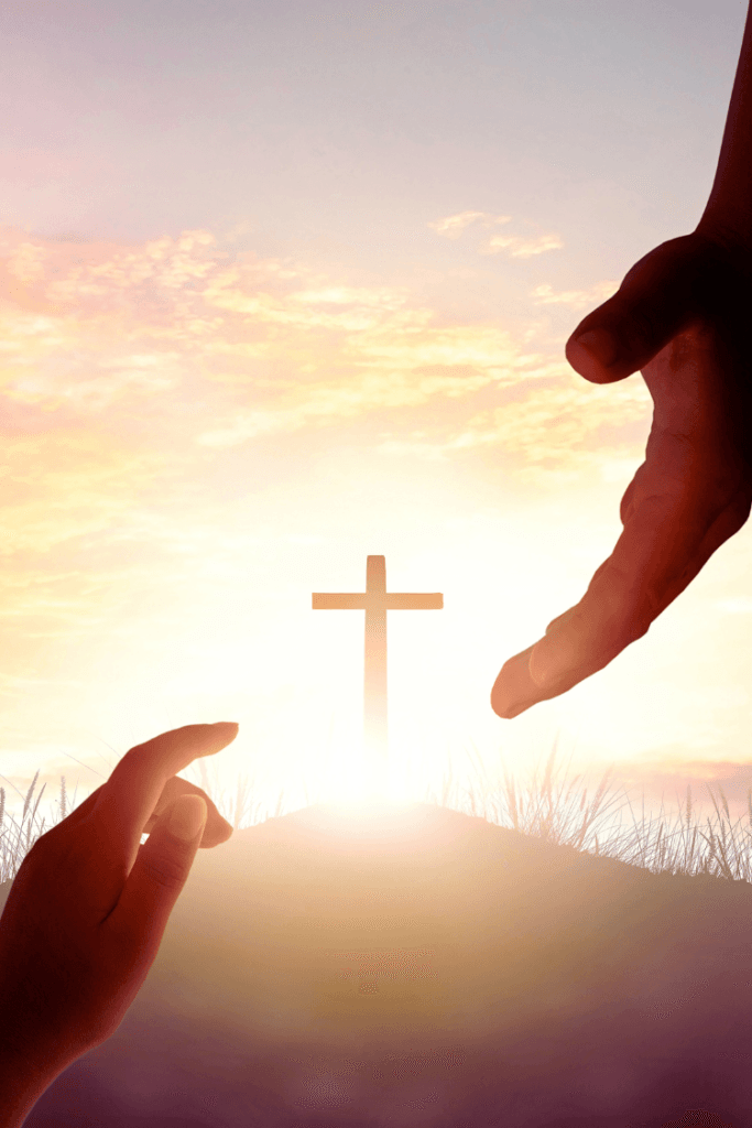 How to Find Your Purpose in Life. hand reaching from Heaven toward someone on earth, their hand is reaching up toward the other hand and there's a cross in the background.