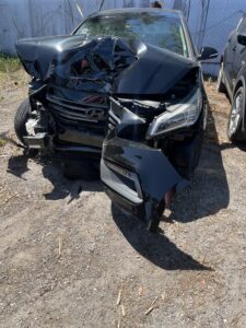 Wrecked Car. Daughter in Hospital Bed..Nicoles car after accident, Her car is black but the whole front of is is smashed in and the right wheel is hanging off to the side. this is right after her accident and it was towed.
