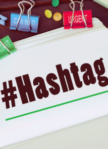 Do hashtags work on pinterest? picture of notbook with the word #Hashtag written on it and a couple clips above that say urgent and can wait.