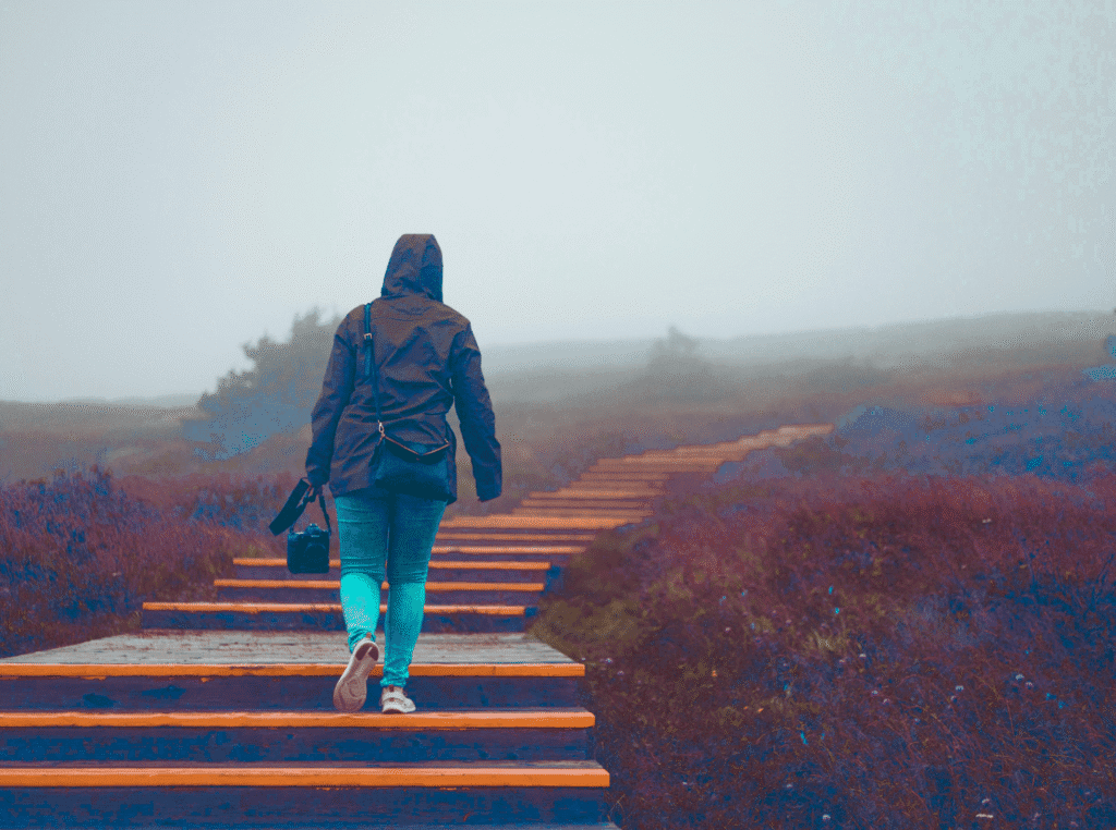 What is a call to action? image outdoors with a very long stairway. there's a woman with her back facing us and she's got her foot up to take the next step. Representing the reader's next step.