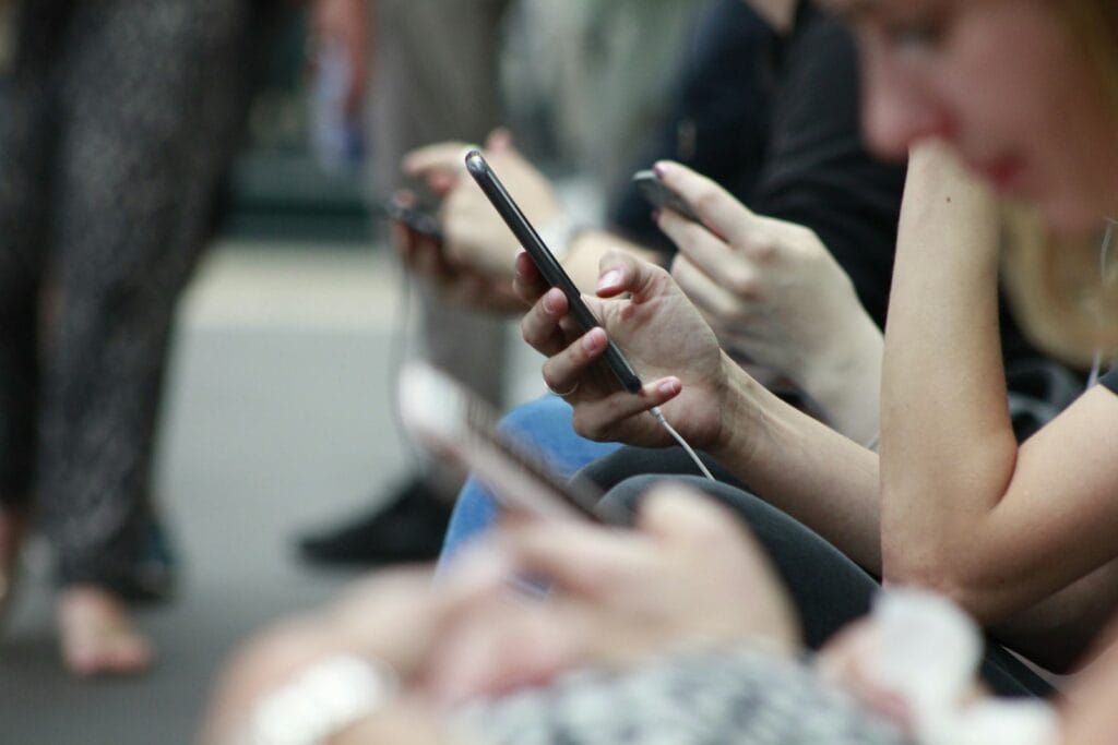 Does Social Media Affect Mental Health? people holding black phones