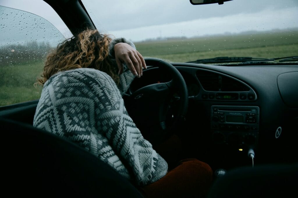 Ways to improve mental health. person in gray and white sweater driving car