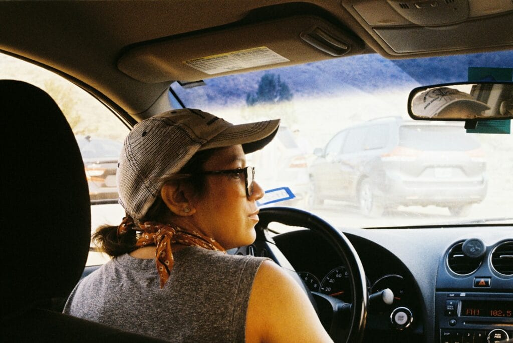 The magic of ordinary days. a woman driving a car in a parking lot
