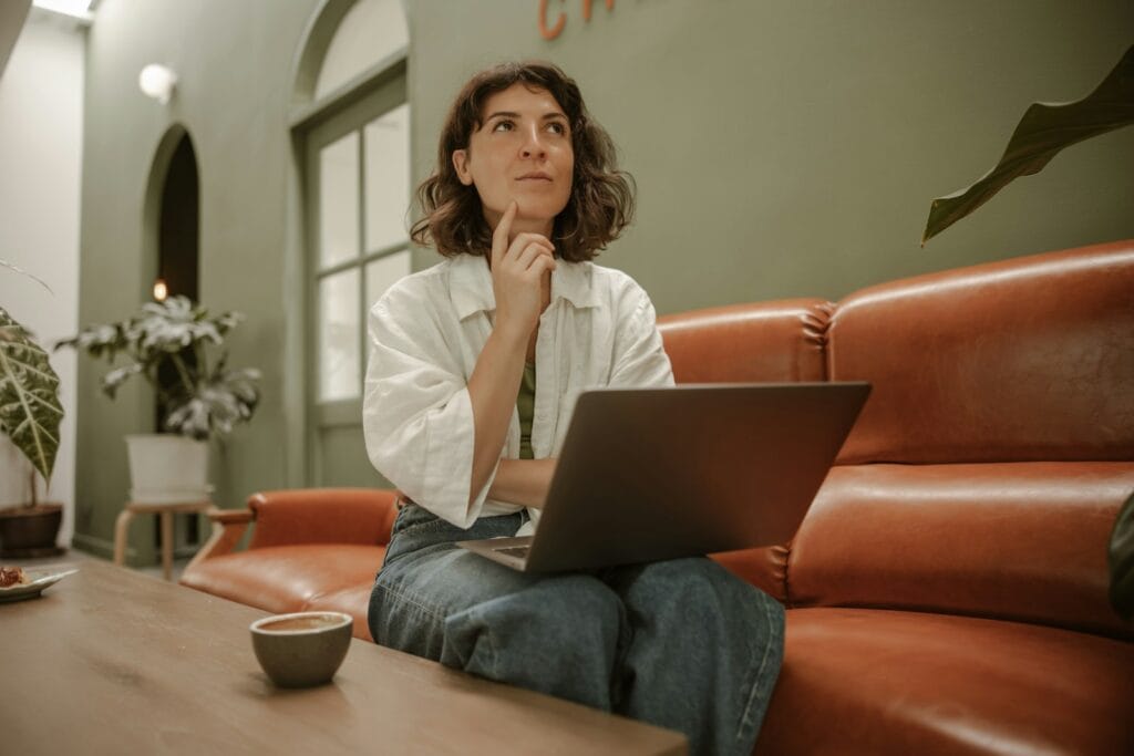 what does call to action mean. a woman sitting on a couch using a laptop computer