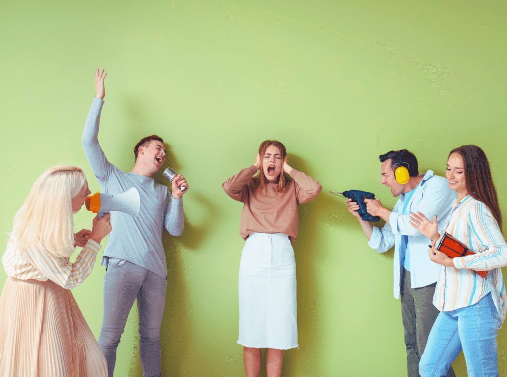 How do you use keywords on pinterest. several people making loud noises with one woman in the middle with her hands over her ears and her mouth open. the background is green.