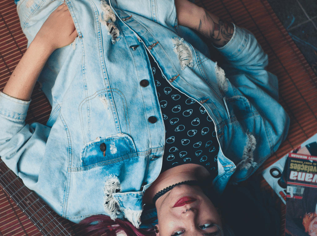 be careful what you tolerate you are teaching. woman laying on the floor with a sad or overwhelmed look on her face. hands in pocket...feeling like a doormat.