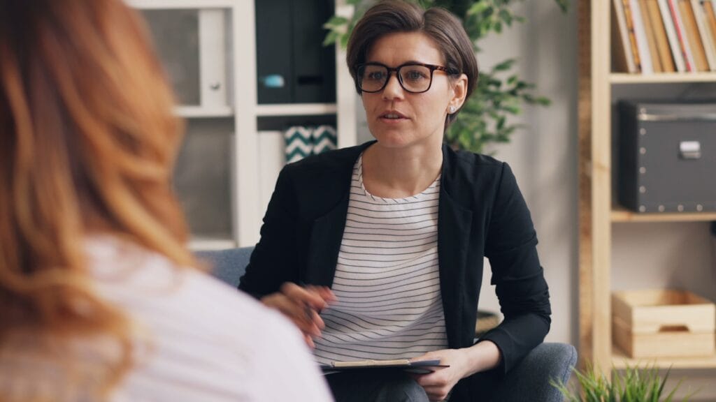 Having Hard Conversations. a woman sitting on a couch talking to another woman