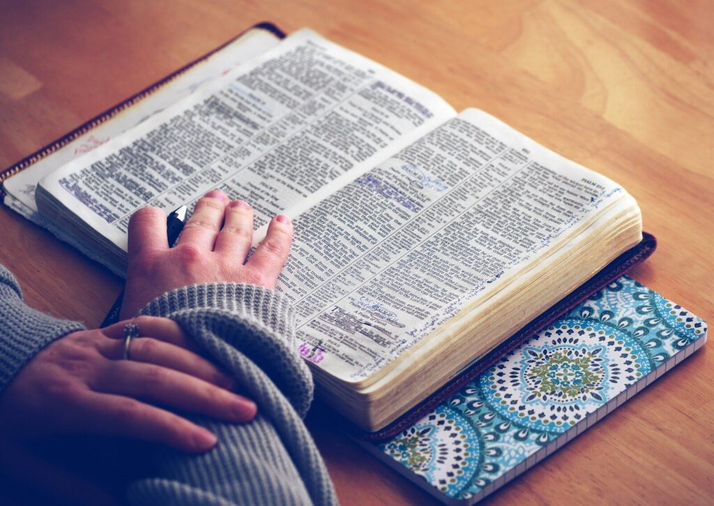change your mindset. person reading a book with hands on top of book