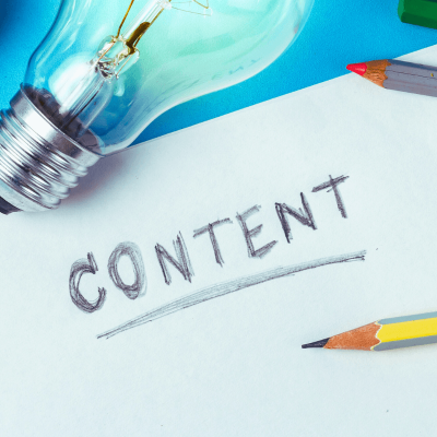Content pillars. a paper with the word content, written in pencil. there's a pencil next to it and a light bulb too.