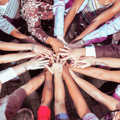How do you find your niche market? A group of diverse people holding their hands in a circle to represent all the different peoples of the world you can choose from for your niche market.