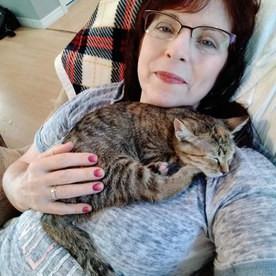 Is There a Link Between Mental Health and Cats? this is me and my kittty Sasha and she's laying on my chest cuddling.