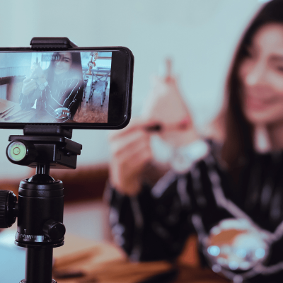 Is your social media persona the same in real life. woman influencer on a live stream smiling. (her online persona)