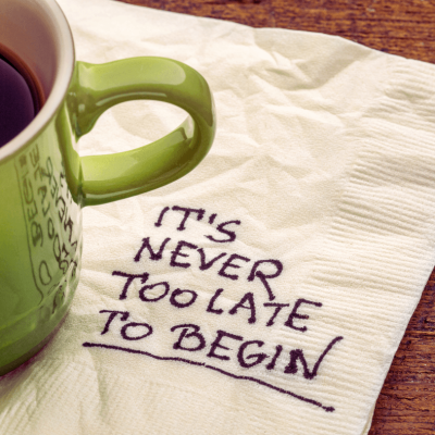 How to Find Your Purpose in Life. Green cup of coffee sitting on a white napkin that says It's never too late to begin.