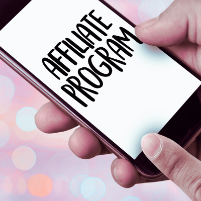 best affiliate marketing programs. persons hands holding a cellphone with the words affiliate program on the screen.