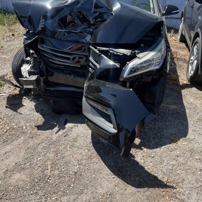 Wrecked Car. Daughter in Hospital Bed..Nicoles car after accident, Her car is black but the whole front of is is smashed in and the right wheel is hanging off to the side. this is right after her accident and it was towed.