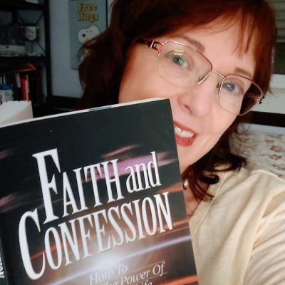 careful with your words. image of me smiling and holding the book faith and confession by charles capps.