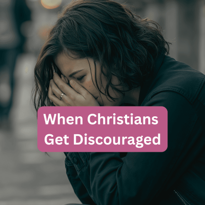 christians get discouraged. woman sitting on a sidewalk bench with her face in her hands and it looks like she's very upset.