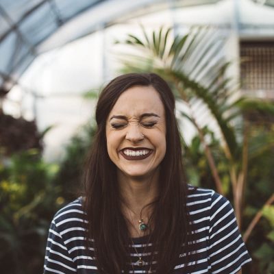 be the person you want to be. woman smiling while standing in garden