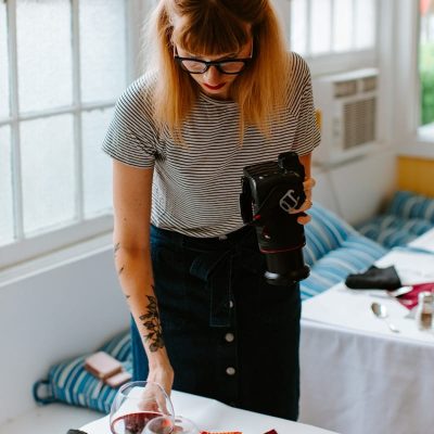 What is content creation? woman in black and white stripe shirt holding black dslr camera