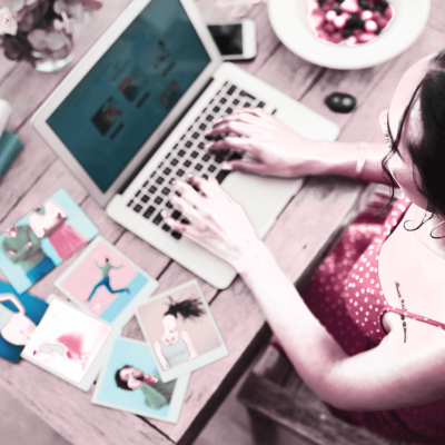 Should I start a blog or a marketing funnel? woman typing at laptop with papers beside her and a bowl on the other side. It looks like she's busy working on building a blog or a funnel.