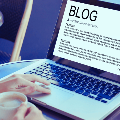 tips for writing a blog. image of someone on a laptop with the screen saying Blog at the top and words below.