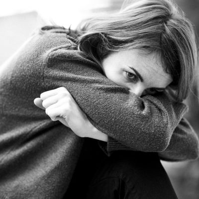 Breath Prayers for Anxiety. a black and white photo of a woman sitting on a bench